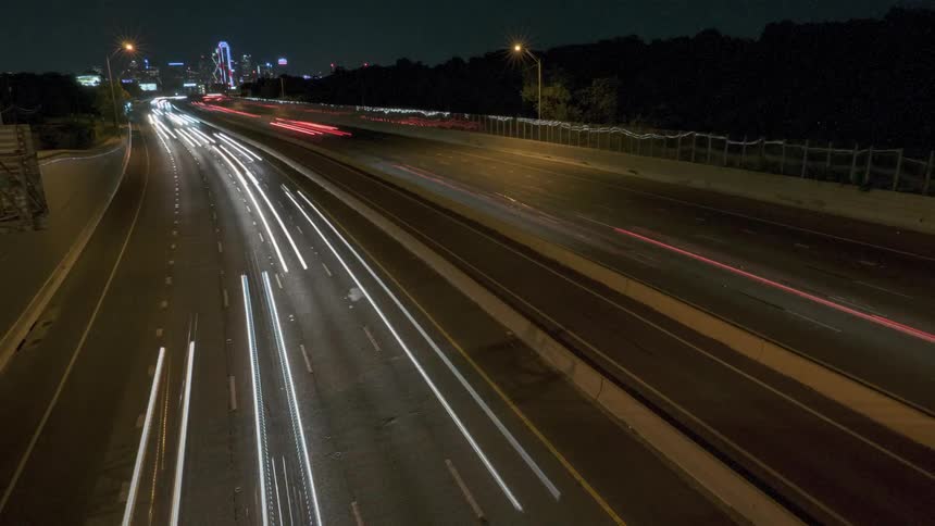 Vehicles travel down a highway at night