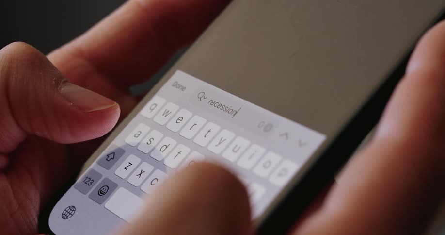 A person types a word in the search bar on their phone