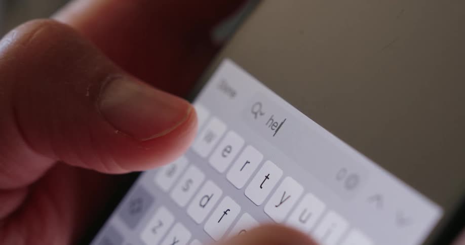 A person types the word help on his cell phone