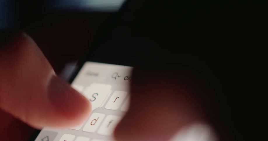 A person typing on their smartphone using their thumbs