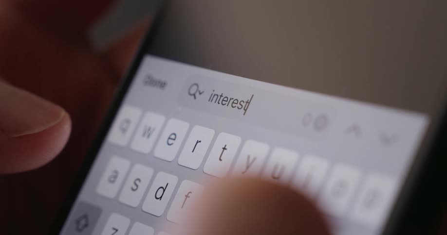 The person searches the word interest on their phone