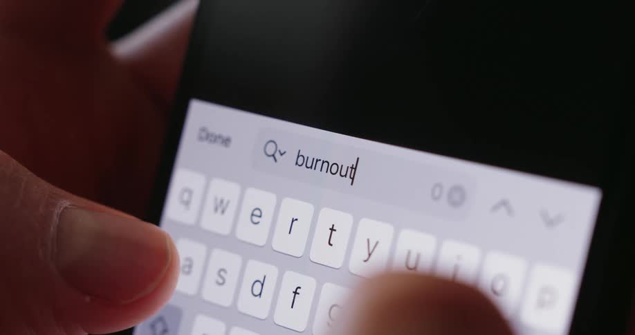 Close up of a pair of hands typing on a smartphones virtual keyboard