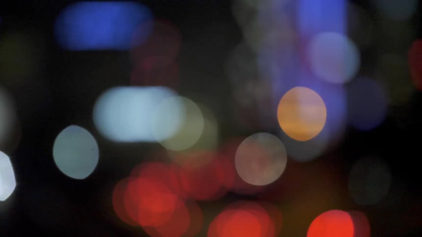 The cars have blurry lights in the distance