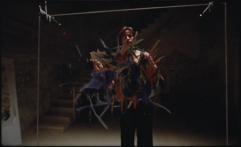 Man standing painting a glass picture