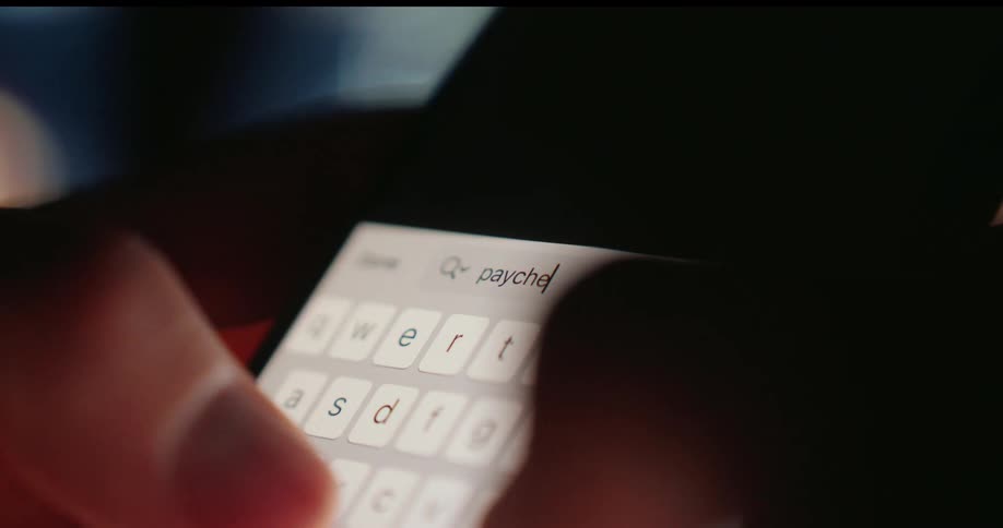 A person searches the word paycheck with their cell phone