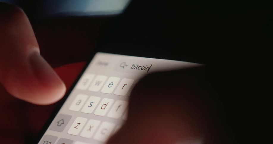 The person types bitcoin into the cell phone search engine