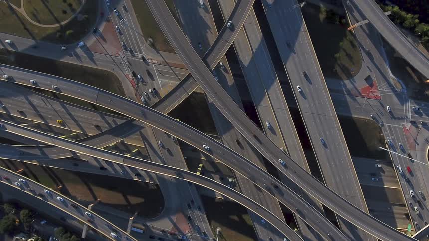 Vehicles drive on a busy highway system