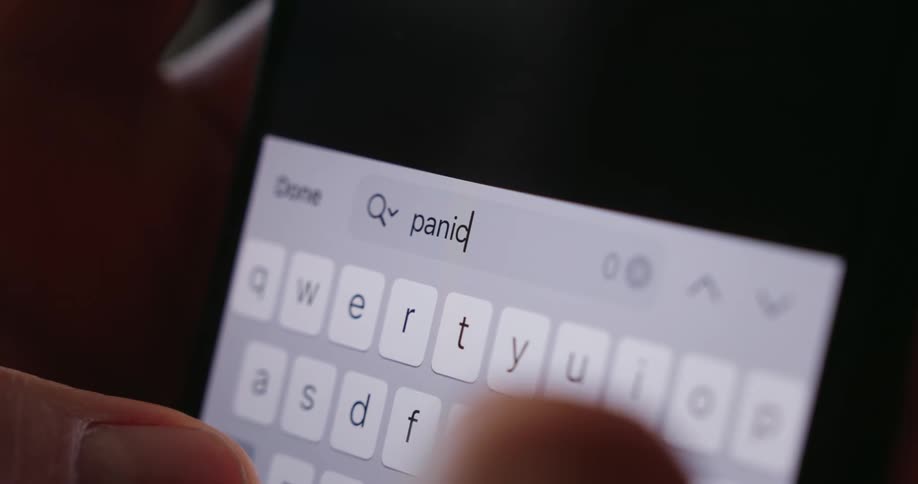 A person typing the word panic on a smartphone