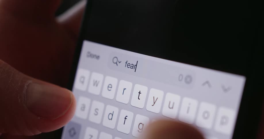 Close up of a persons hands typing on a smartphone