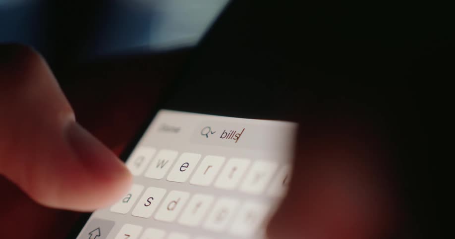 A person searches the word bills on his cell phone