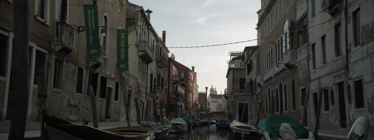A canal is full of docked boats