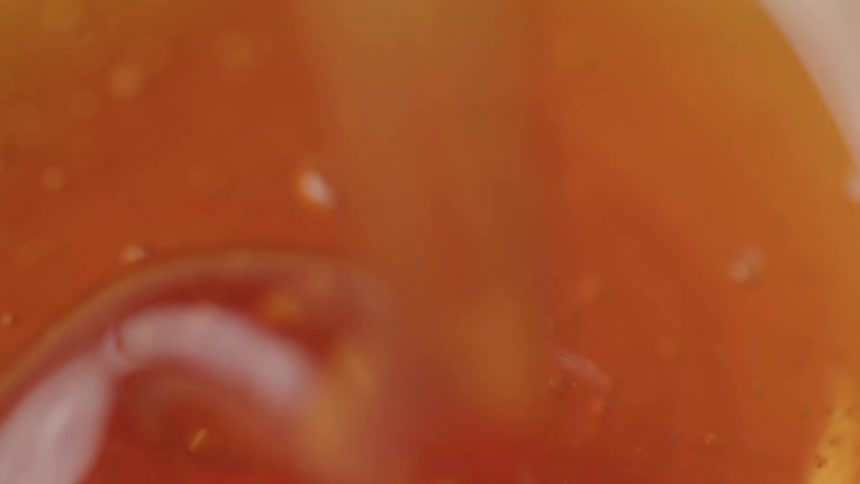 Close up of a spoon scooping up some honey