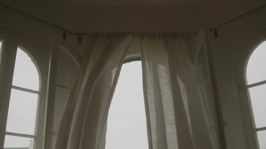 Curtains billow in the breeze