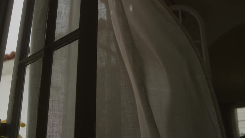 Wind blows the curtain on the doorway