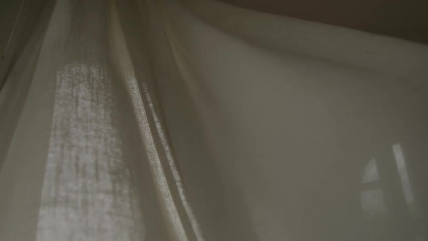 Curtains billow in the wind