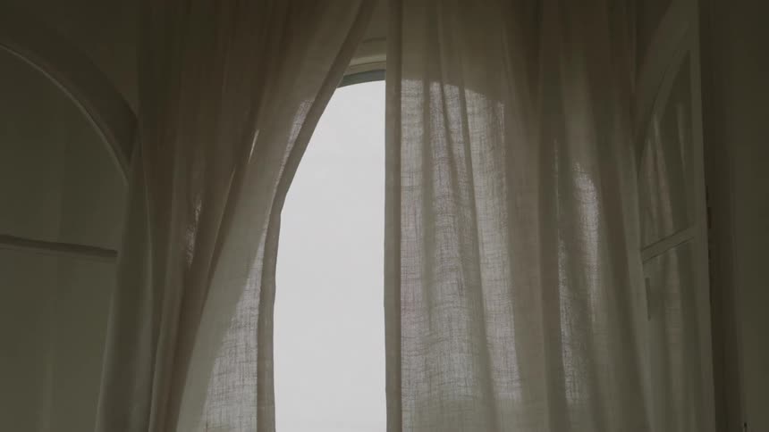 Curtains sway in the breeze