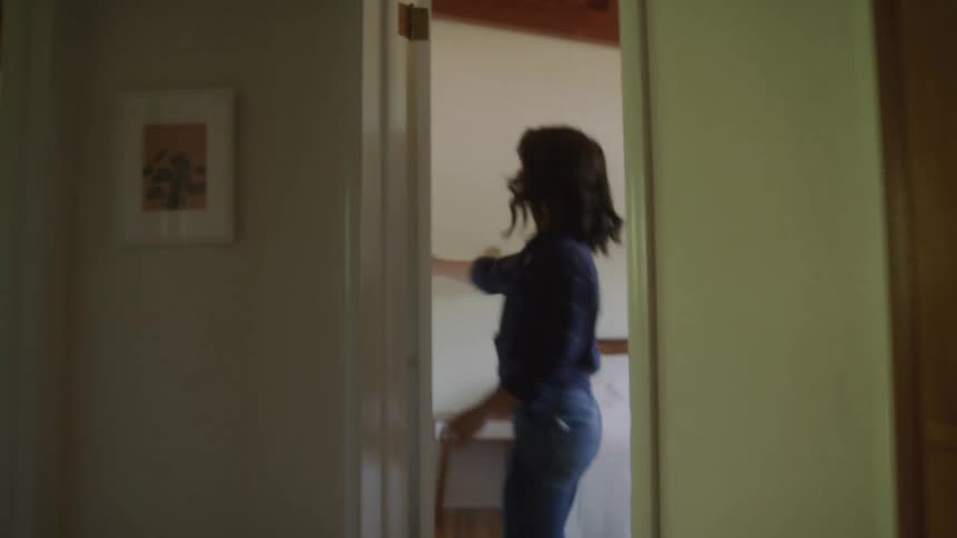 Woman entering a room and closing the door