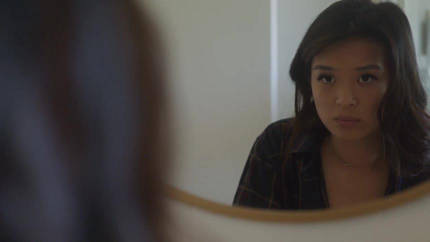 Woman looking at herself in the mirror
