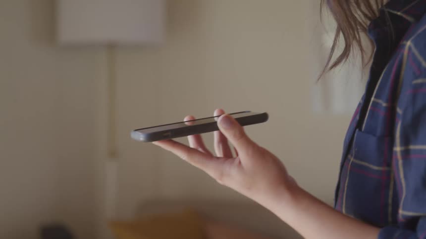 A woman is on a speakerphone call gesturing with her hand as she talks
