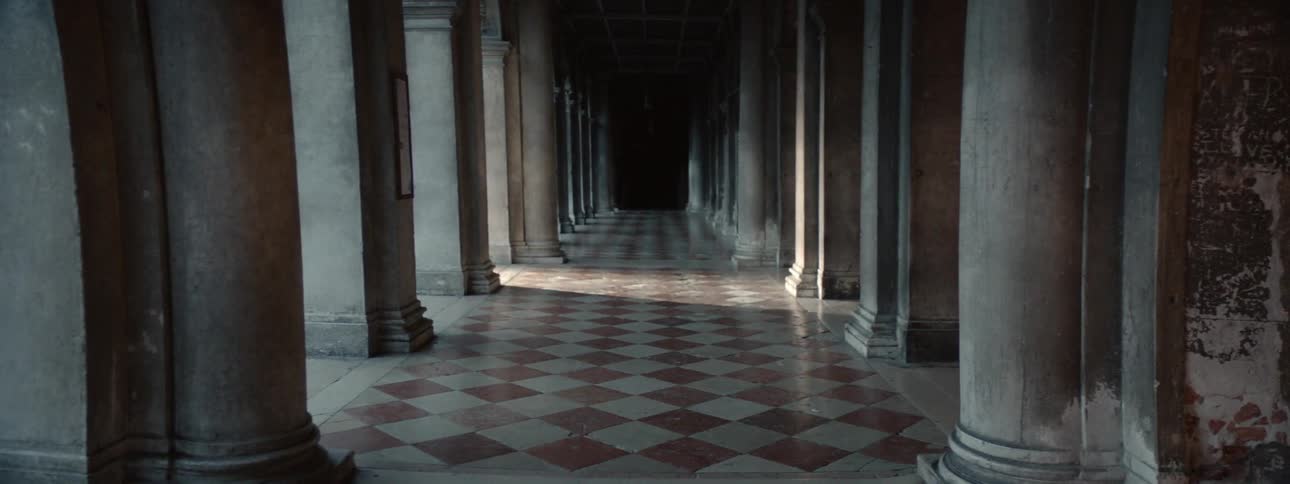 Sunlight moves down an open walkway with columns
