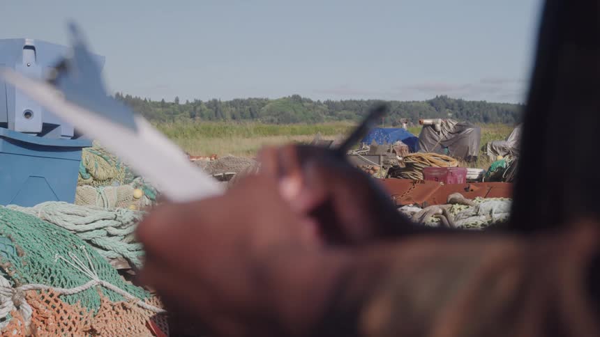 Pair of hands of a person writing on a clipboard