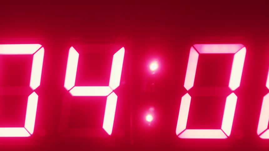 Close up of numbers counting down on a flickering neon red timer