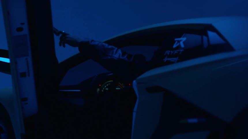 Man getting into a lamborghini and closing the door