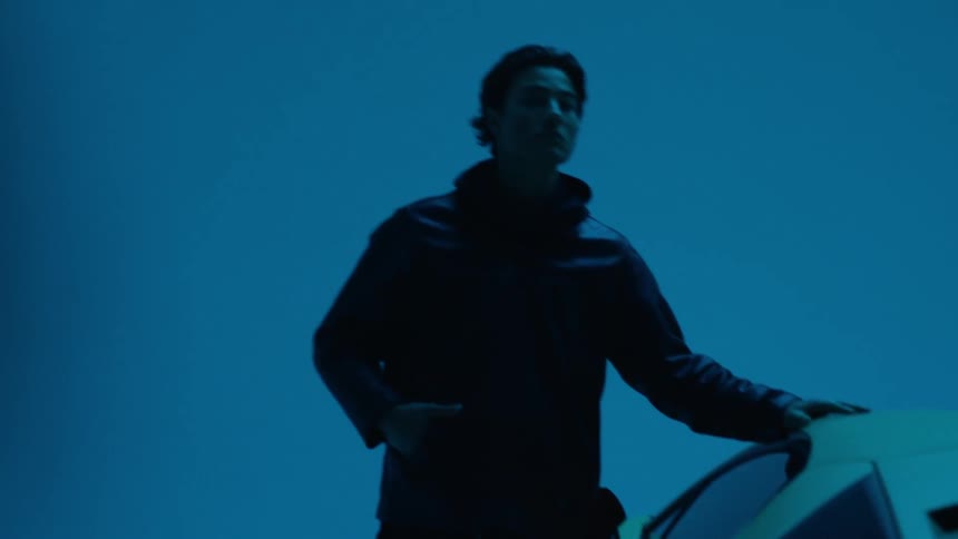 A man touches the car as the lights flash