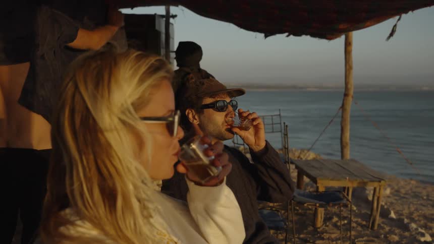 People are having drinks on the beach