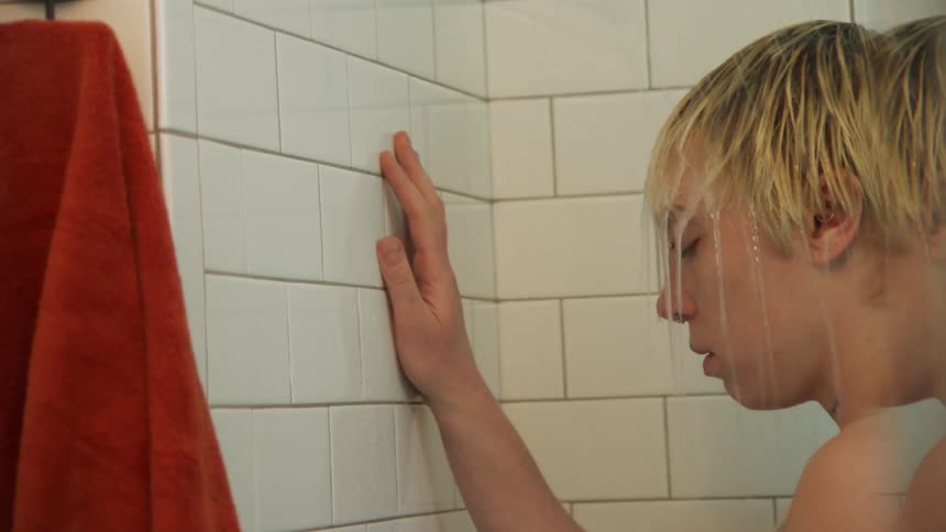 Portrait of a man entering the shower and taking a bath