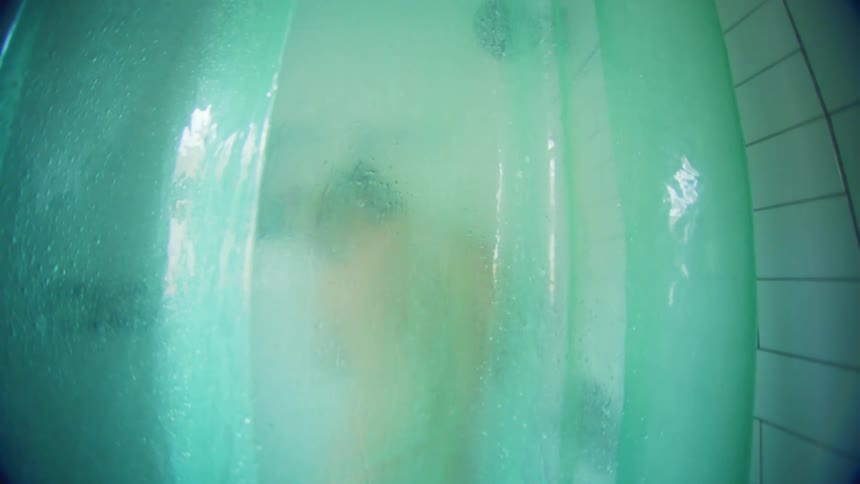 View through a transparent curtain of a person bathing and dancing
