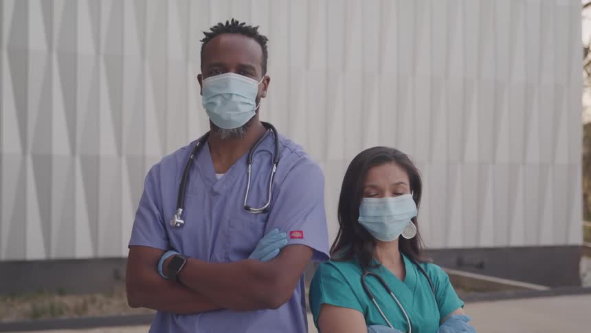 Man and woman healthcare professionals wearing masks