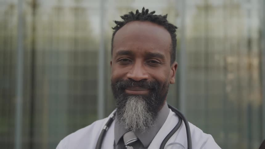 The doctor turns his head and smiles