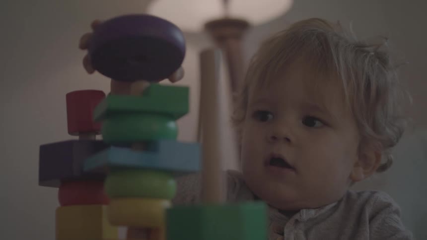 Baby playing with colorful toys