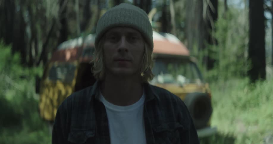 A man walks from his van in the forest