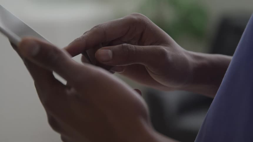 A doctor slides his finger on the tablet