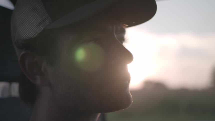 Portrait of a man wearing a cap inside a car