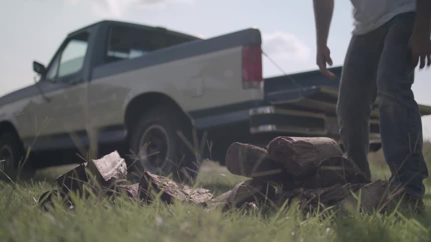 A man loads wood into his truck
