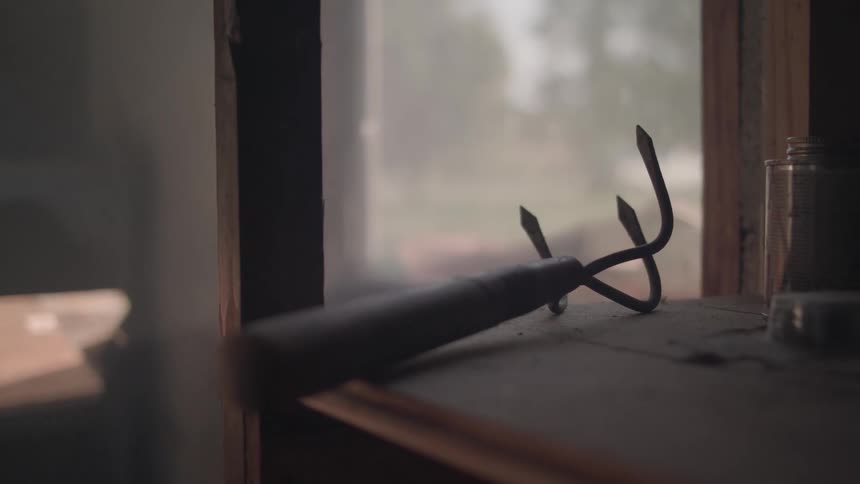 A garden tool on a shelf