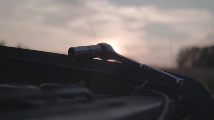 Closeup of a metal tool on the surface of a vehicle