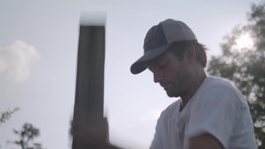 A man is planting a post outside