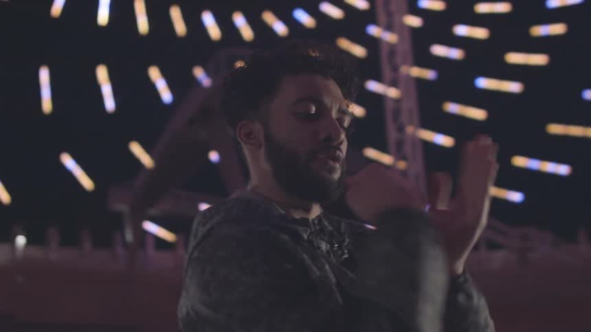 Man dancing in a performance in an environment with abstract lights