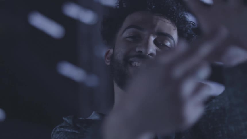 Portrait of a curly haired man dancing