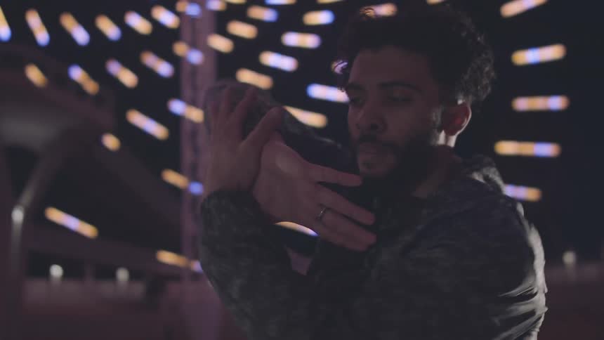 A man is dancing and waving his hands around