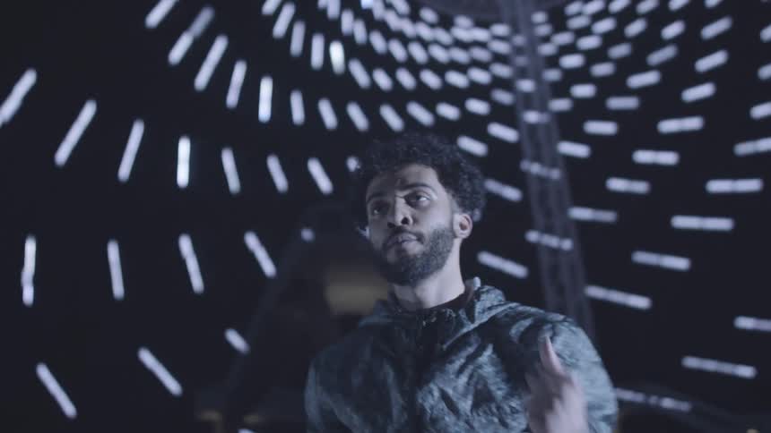 Man in a room with lights at night dancing