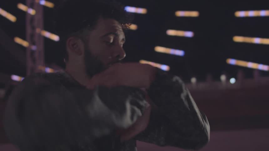Portrait of a man dancing and making hand movements