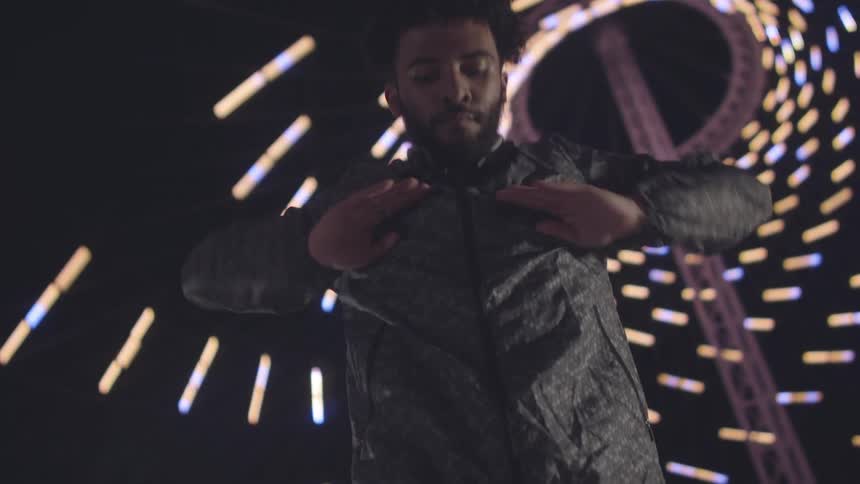 Man dancing in an environment with a spiral of lights