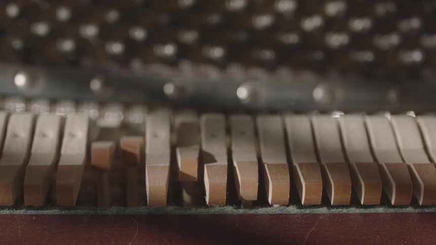 Close up of the outer part of moving wooden keys of a musical instrument