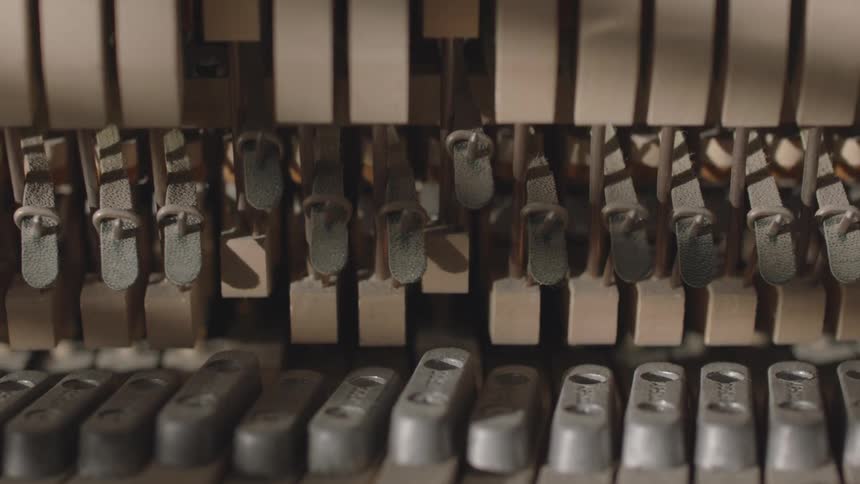 Close up of the back of a piano with the keys moving