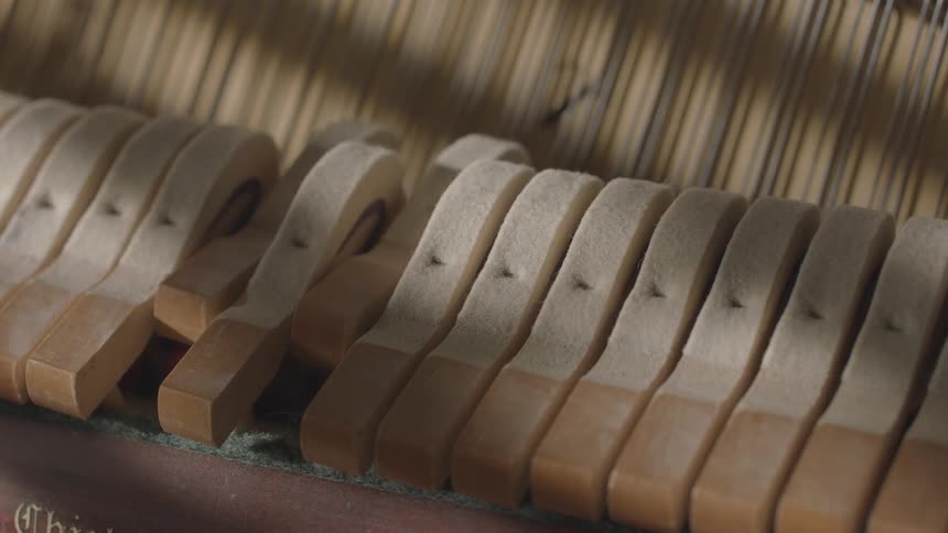 Moving wooden keys of a musical instrument